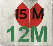 The image on the sticker is a red abstract flower, symbolizing protest. The text on the sticker refers to the dates, May 15th and May 12th of the year 2011.